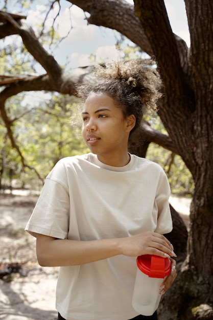 Free Photo side view woman holding water bottle