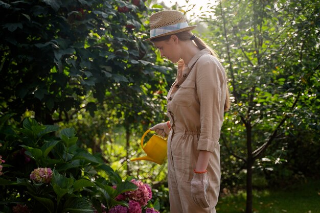 Side view woman holding watering can