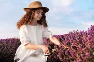 Free photo side view woman in lavender field