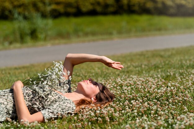 Side view woman laying on grass