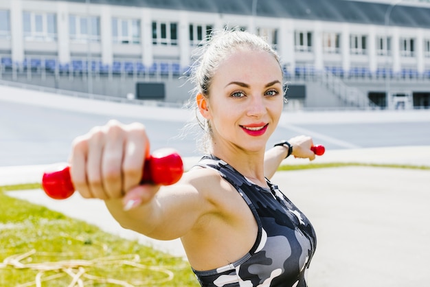 Side view of woman lifting weights