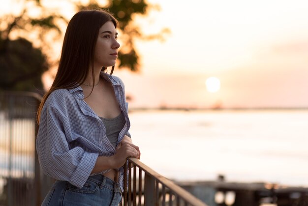 Side view woman looking away at sunset