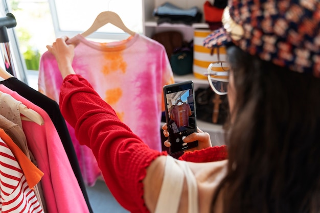 Free photo side view woman looking at clothes