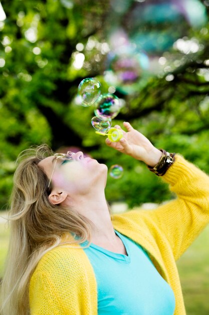 Side view woman making bubbles