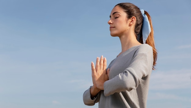 Side view woman meditating in nature