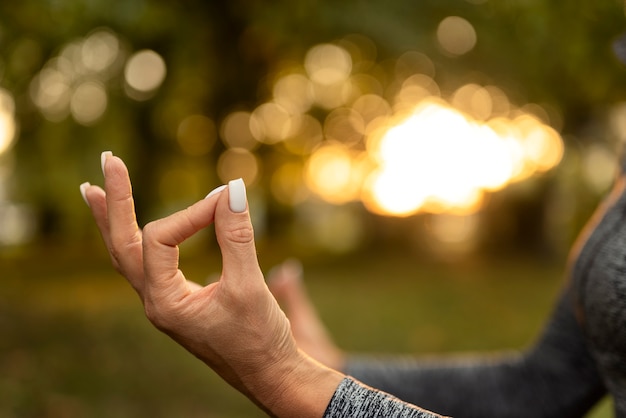 Side view woman meditating outdoors