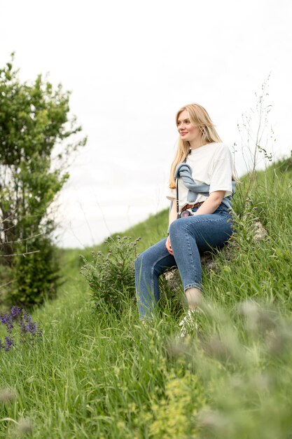 Side view of woman posing in grass