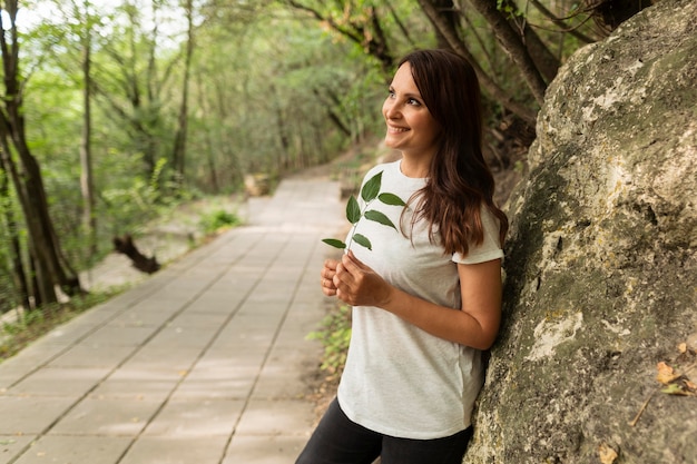 Free photo side view of woman posing in nature