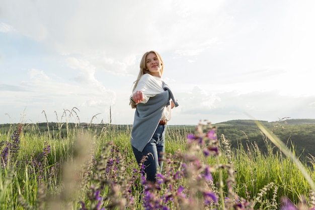 Side view of woman posing through field