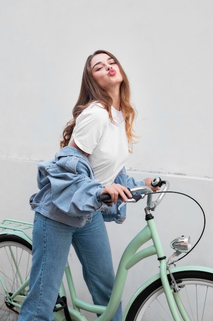 Side view of woman pouting her lips while sitting on her bike