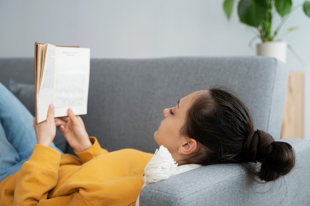 Side view woman reading on couch