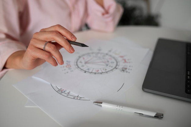 Free Photo side view woman reading tarot with laptop