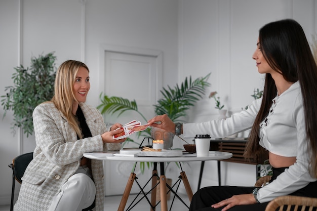 Free Photo side view woman reading tarot