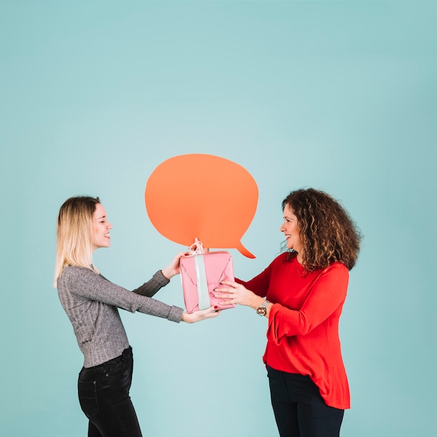 Free Photo side view woman receiving present from daughter