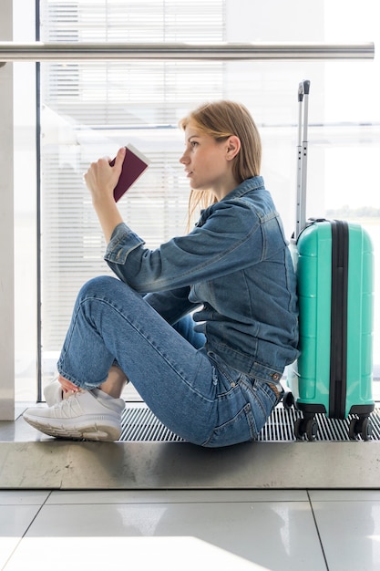 Free Photo side view of woman sitting in airport