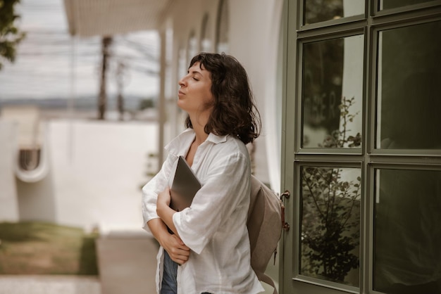 Side view of woman staying with laptop