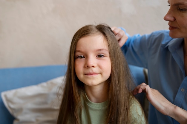 Side view woman taking care of girl