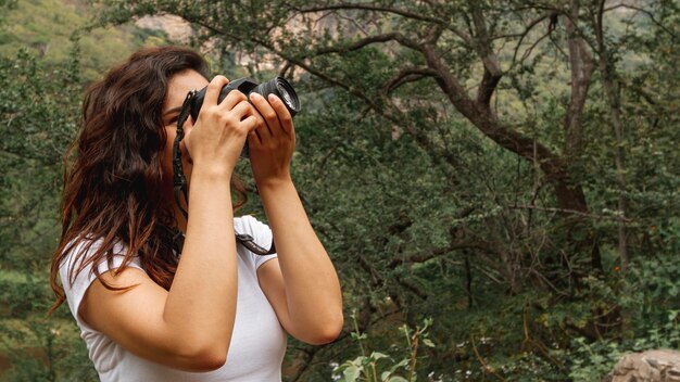 Side view woman taking photos of nature