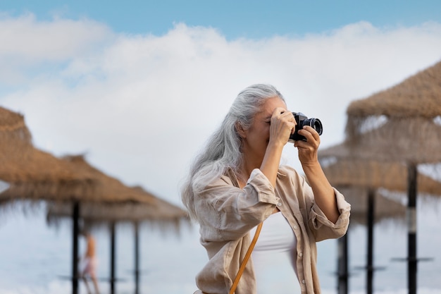 Side view woman taking photos