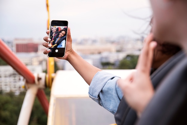 Free photo side view woman taking selfie