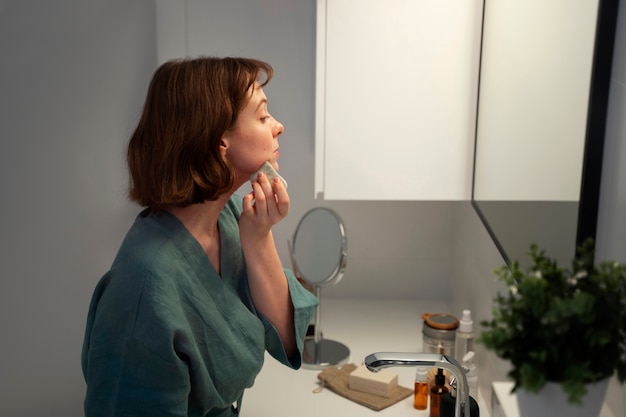 Side view woman using gua sha for massage