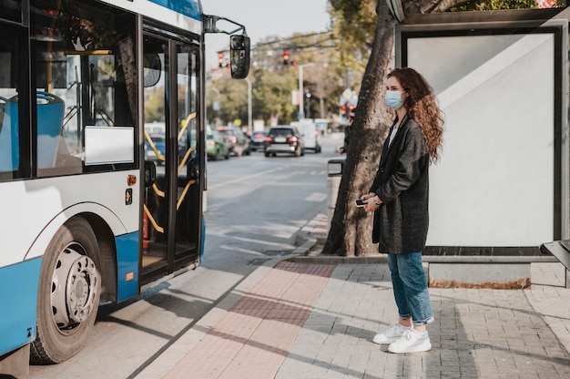 Free photo side view woman waiting for the bus