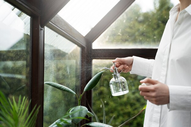 Side view woman watering plants