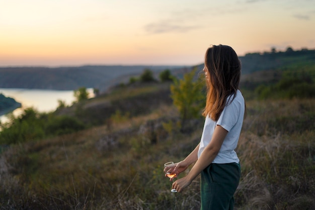 Free photo side view woman with drink outdoors