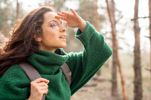 Side view woman with glasses traveling