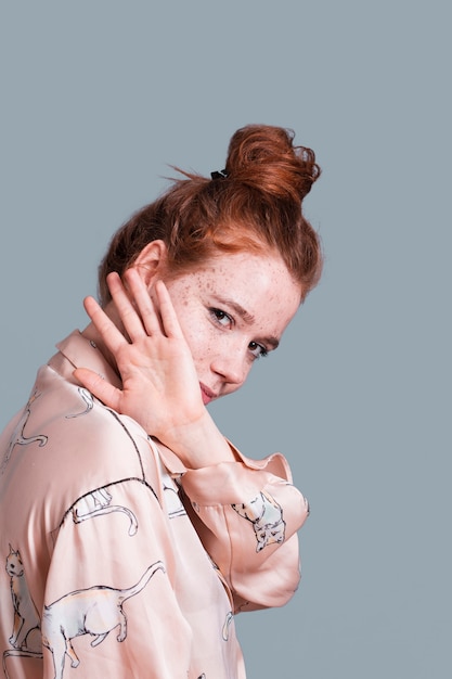 Free Photo side view woman with hair bun posing