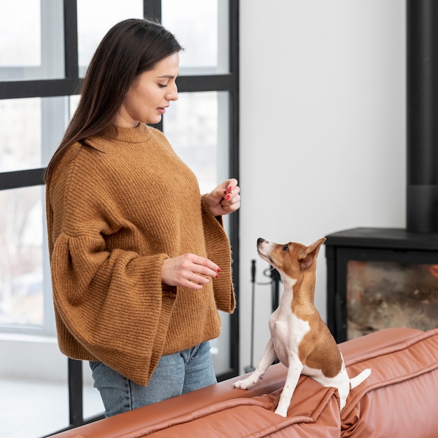 Side view of woman with her dog on the couch