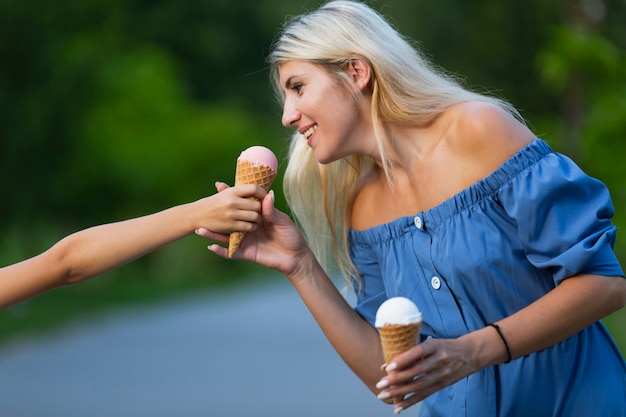 Free photo side view of woman with ice cream cones