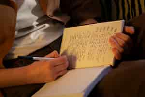 Free photo side view woman with journal at home