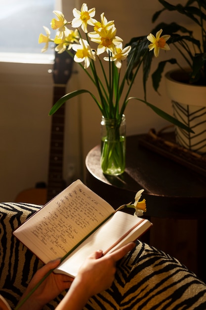 Free photo side view woman with journal at home