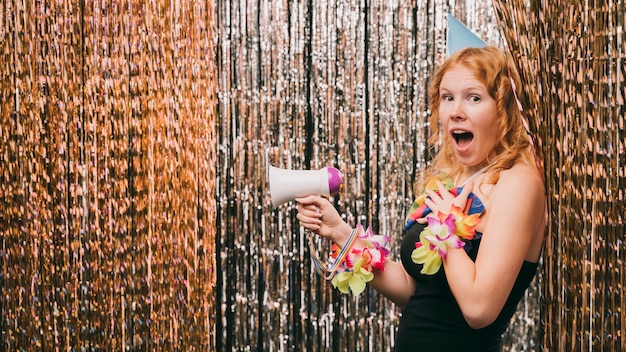 Free photo side view woman with megaphone at carnival party