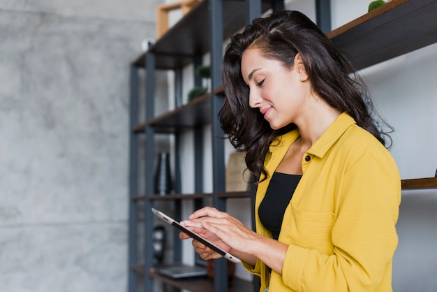 Side view woman with tablet