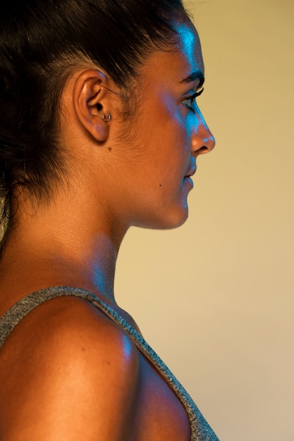 Side view of woman with yellow background