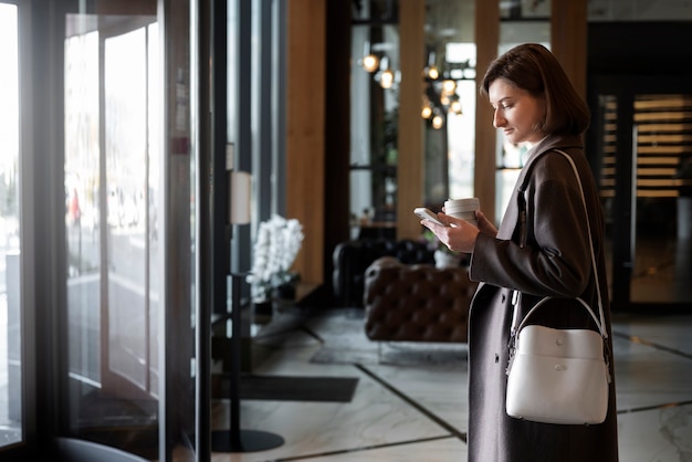 Side view woman at work with coffee cup