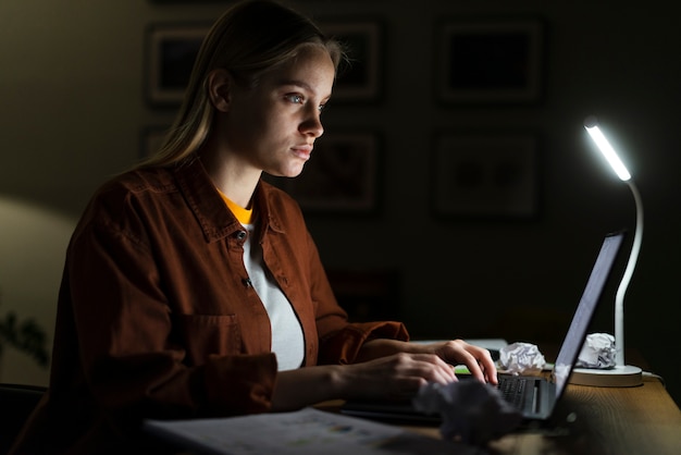 Side view of woman working at desk