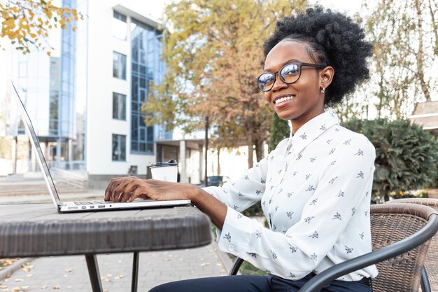 Side view woman working on electronic device