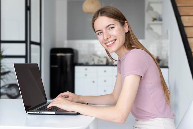 Free Photo side view woman working on her laptop