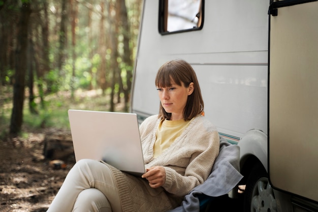 Free photo side view woman working on laptop