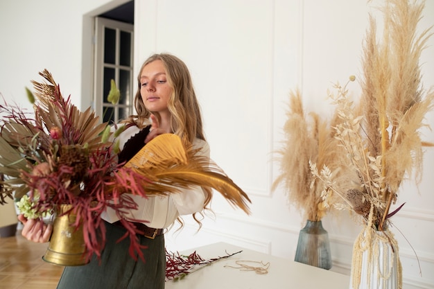 Side view woman working with flowers