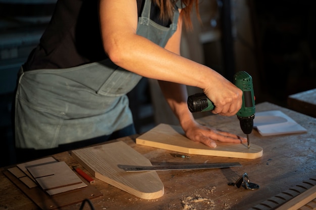 Free photo side view woman working with wood