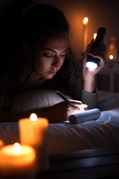 Side view woman writing in bed