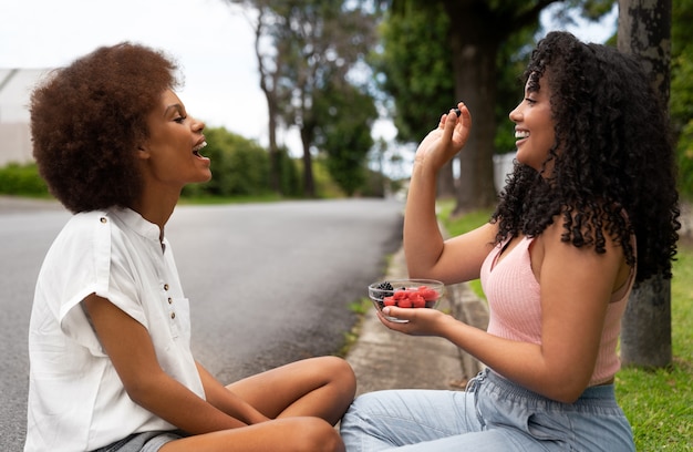 Side view women eating berries