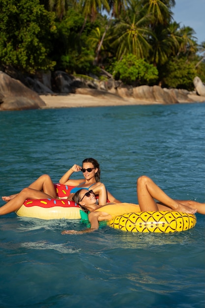 Side view women laying on floaters