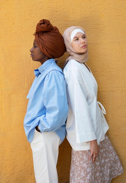 Side view women posing together