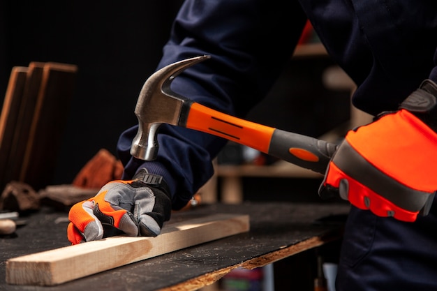 Free Photo side view worker using hammer