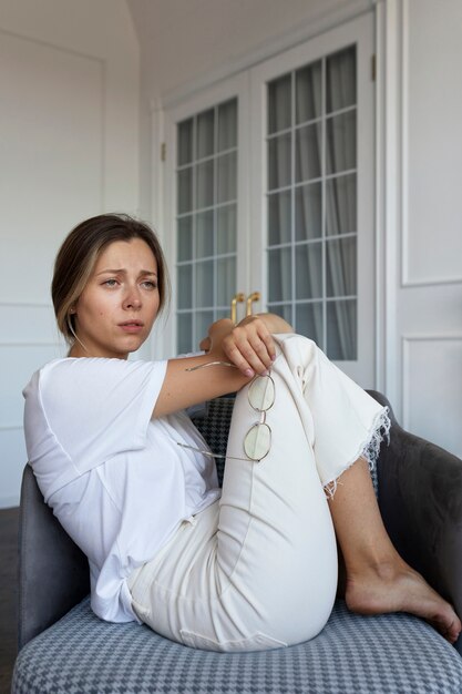 Side view worried woman sitting on chair